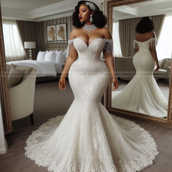 a woman is standing in front of a mirror wearing a wedding dress with an off the shoulder neckline