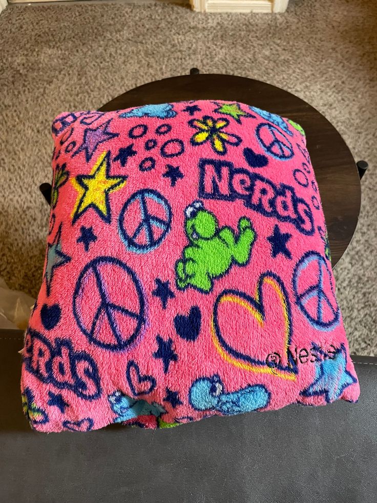 a pink pillow with peace and teddy bears on it