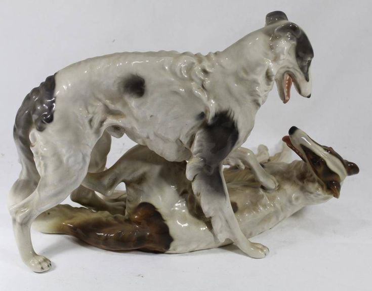 a figurine of two dogs playing with each other