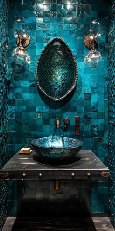 a bowl sink sitting under a mirror in a room with blue tiles on the walls