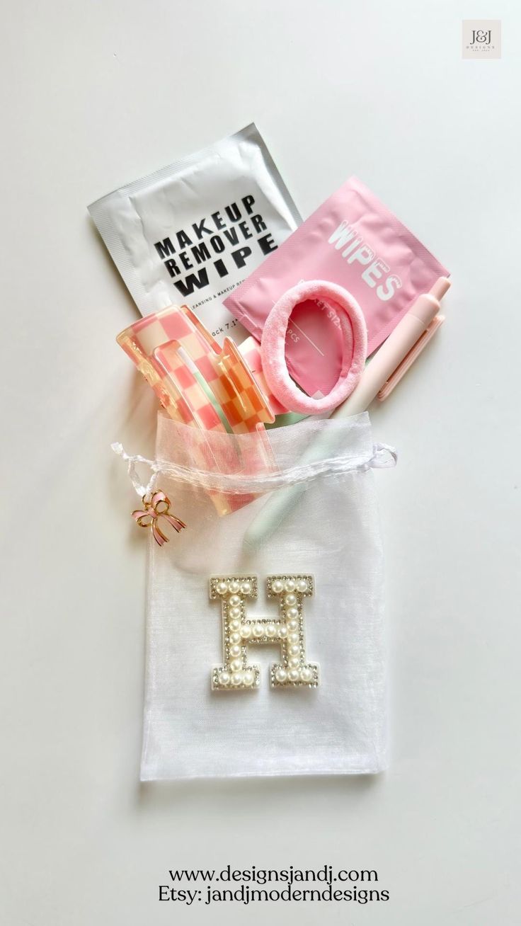 some items are laying out on a white surface and one has a pink mug in it