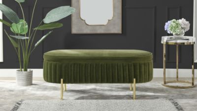 a living room with green velvet upholstered bench and two side tables in the corner