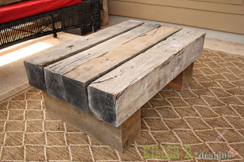 a wooden bench sitting on top of a rug