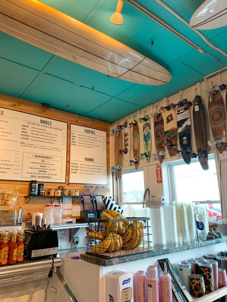 the interior of a restaurant with menus on the wall and food items hanging from the ceiling