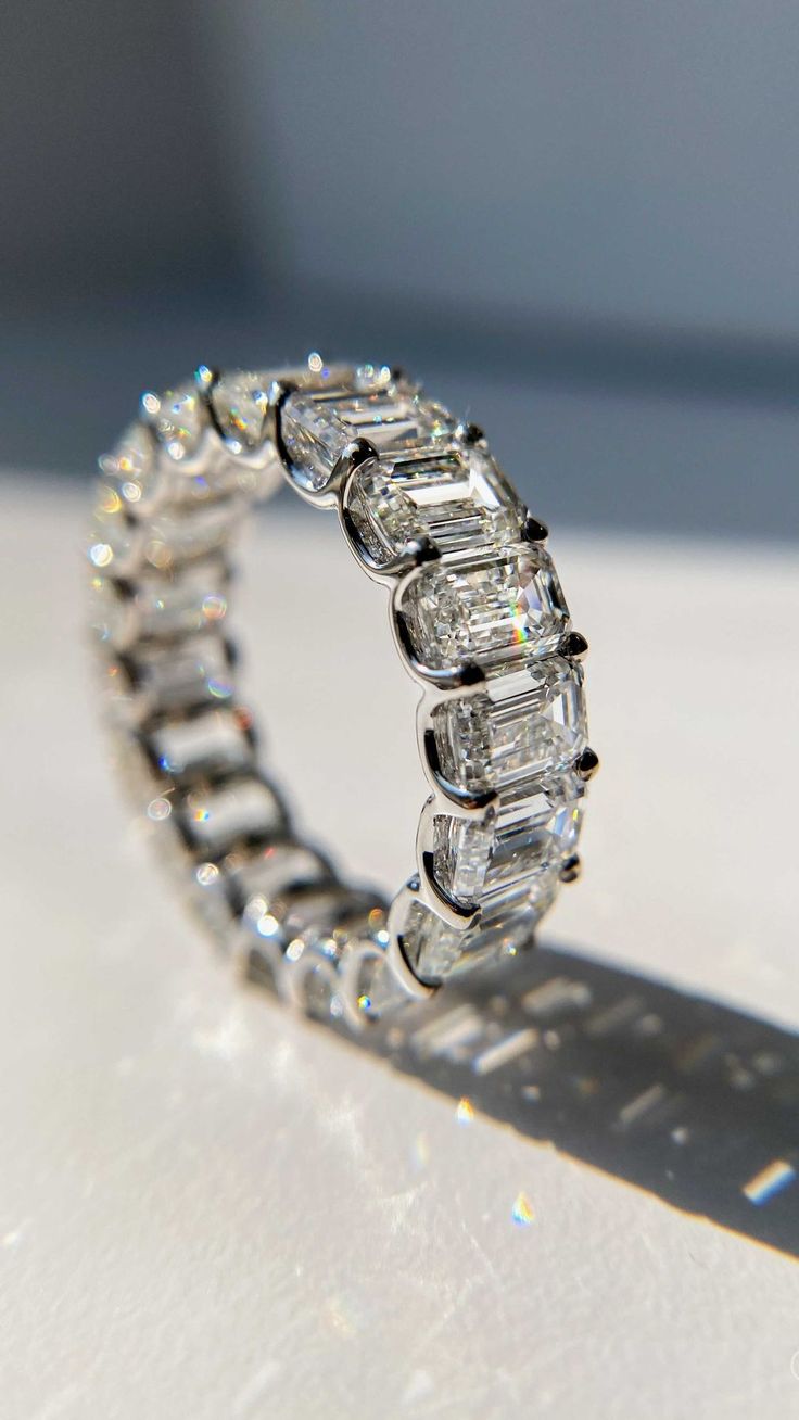 a diamond ring sitting on top of a table