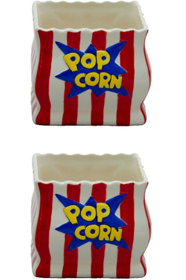 two red and white striped popcorn boxes with pop corn on them