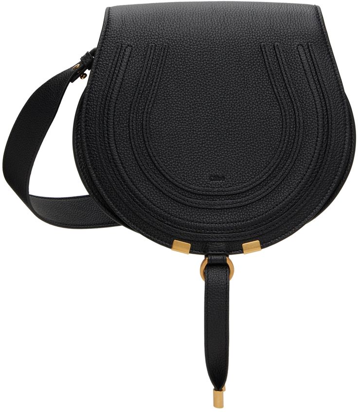 LWG-certified grained calfskin shoulder bag in black. · Adjustable and detachable crossbody strap · Logo embossed at face · Concealed patch pocket at face · Tab-slot flap · Card slot at interior · Cotton twill lining · Antiqued gold-tone hardware · H8 x W9.5 x D3.25 Supplier color: Black Chloe Marcie, Saddle Bag, Black Media, Crossbody Strap, Saddle Bags, Antique Gold, Cotton Twill, Patch Pocket, Saddle