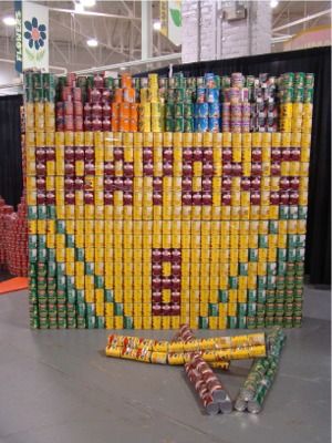 an art installation made out of soda cans and plastic straws on the floor in a warehouse