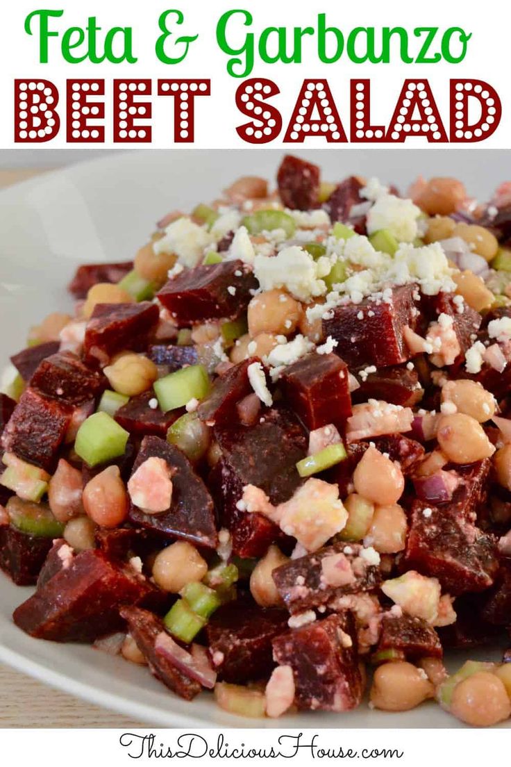 beet salad with feta and garbanzo in a white bowl on a wooden table