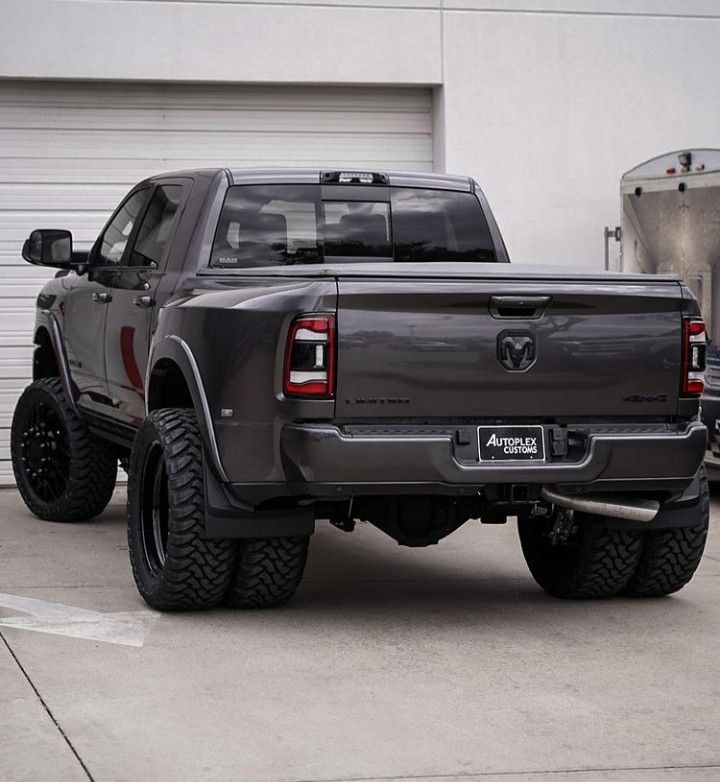 a large gray truck parked in front of a garage