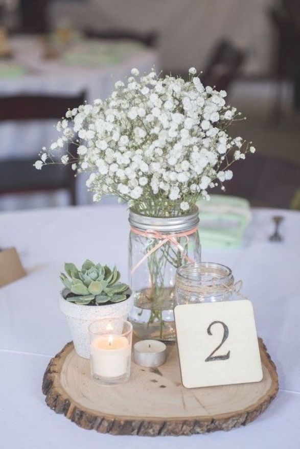 a table with flowers and candles on it