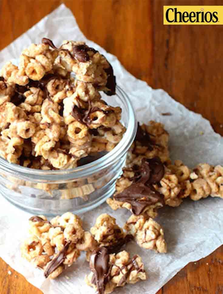 a glass bowl filled with cookies on top of a wooden table next to a napkin