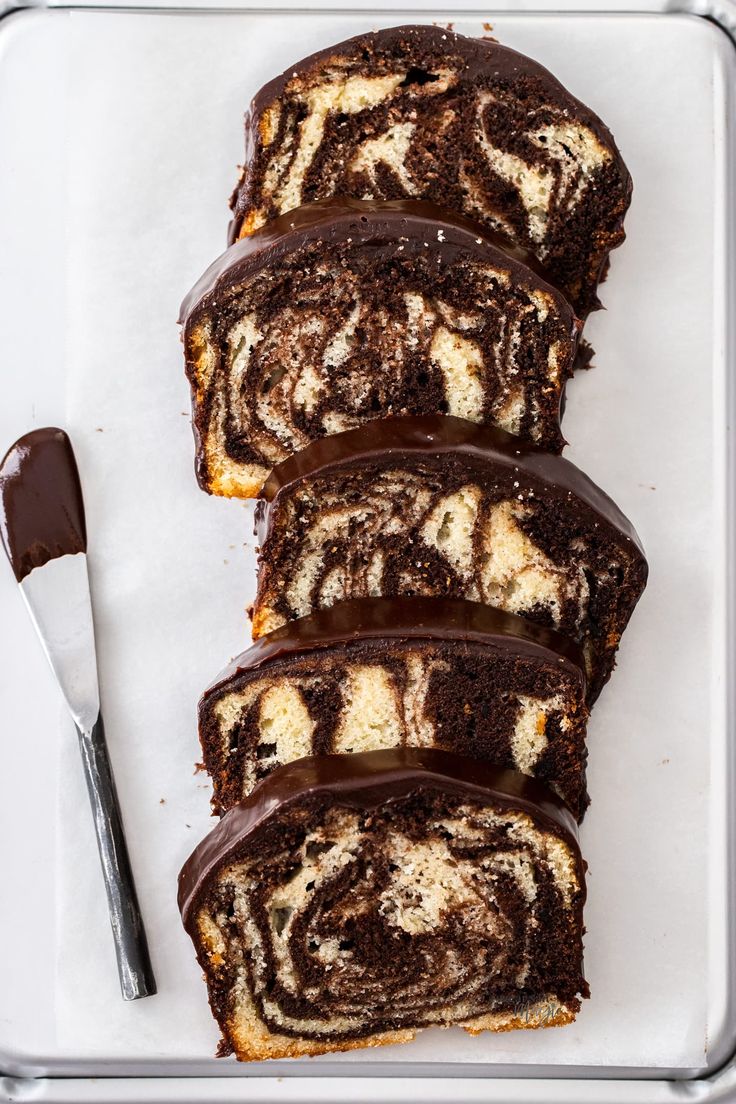 slices of chocolate marbled cake on a tray with a spoon