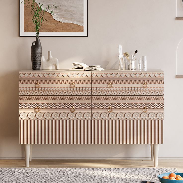 a white and beige dresser in a living room next to a painting on the wall