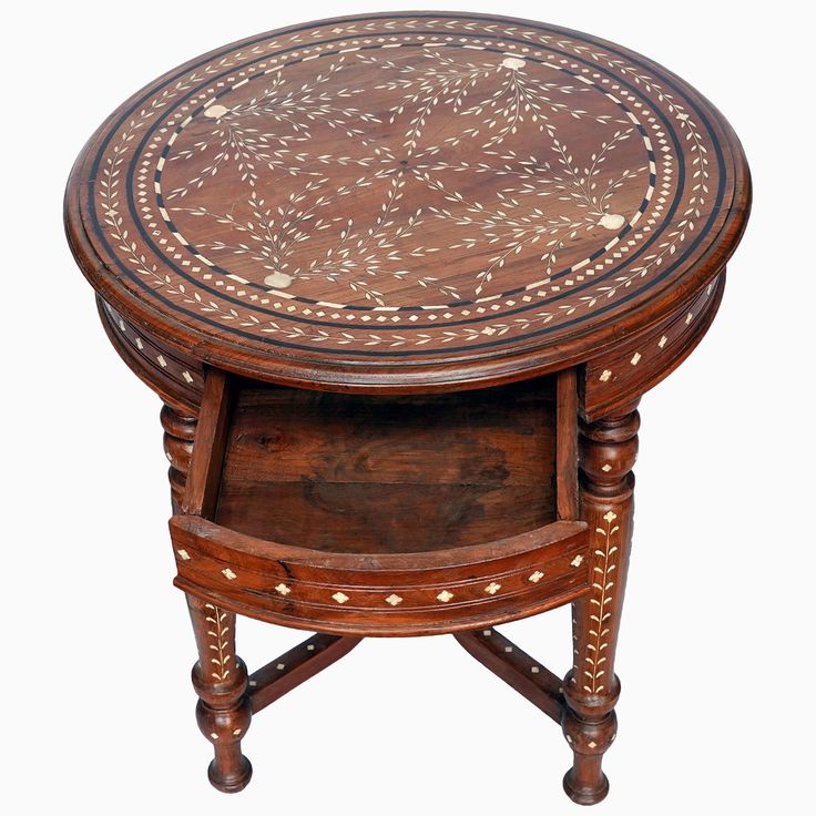 a wooden table with an intricate design on the top