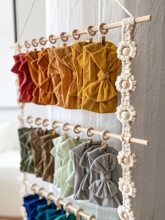 several colors of fabric hanging on a wall