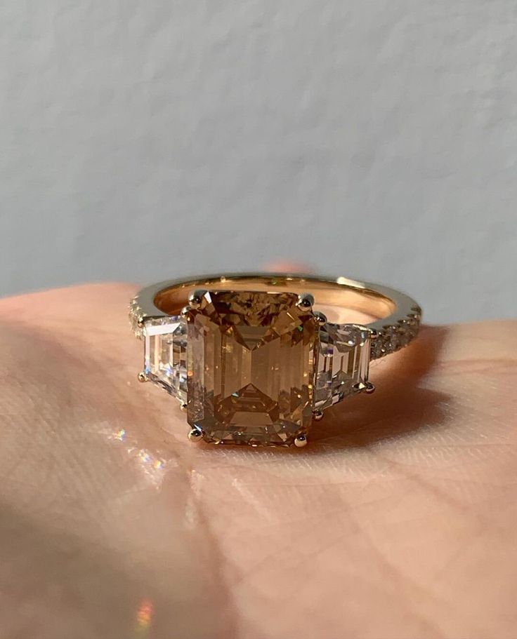 3 CT Brown Emerald Cut And Side Shield Cut Three Stone 10K 14K 18K Solid White Yellow and Rose Gold 925 Sterling Silver Engagement Three Stone Ring R I N G M E T A L ✥ Metal : 10K 14K 18K Solid White Yellow and Rose Gold, 925 Sterling Silver ✥ Metal Clarity : 100% Pure ✥ Stamp/Hallmark : Yes. Will be Indicated Inside The Ring M A I N S T O N E S ✥ Type : Moissanite Diamond ✥ Diamond Shape : Emerald Brilliant Cut Diamond ✥ Diamond Weight : 3 CT ✥ Diamond Color : Brown ✥ Side Diamond Shape ; Shield Brilliant Cut Diamond ✥ Side Diamond Weight : 1.25 Carat ✥ Side Diamond Color : White ✥ Clarity : VVS1 VVS1 ✥ Diamond Cut : Excellence R I N G S I Z E S ✥ All Ring Size are Available ✥ Free Sizing ✥ If You Have any Questions With Regards to Sizing Please Contact as ✥ Please Send me a Message If Yo Brown Engagement Rings, Brown Diamond Ring, Ring Three Stone, Three Stone Ring, Dear Future, Rose Gold Engagement, Stone Engagement Rings, Brown Diamond, Gift Ring