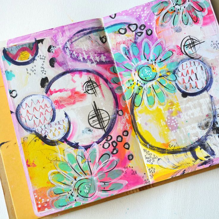 an open art journal with colorful designs on it