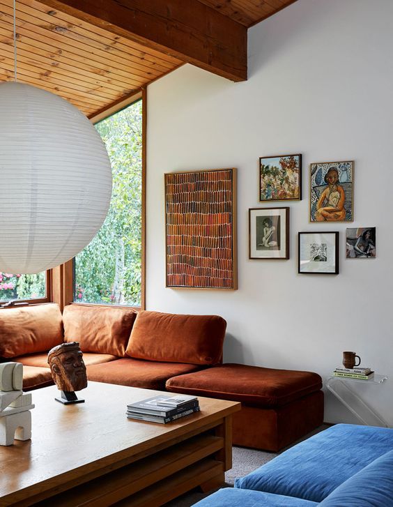 a living room filled with furniture and a large white light fixture hanging from the ceiling