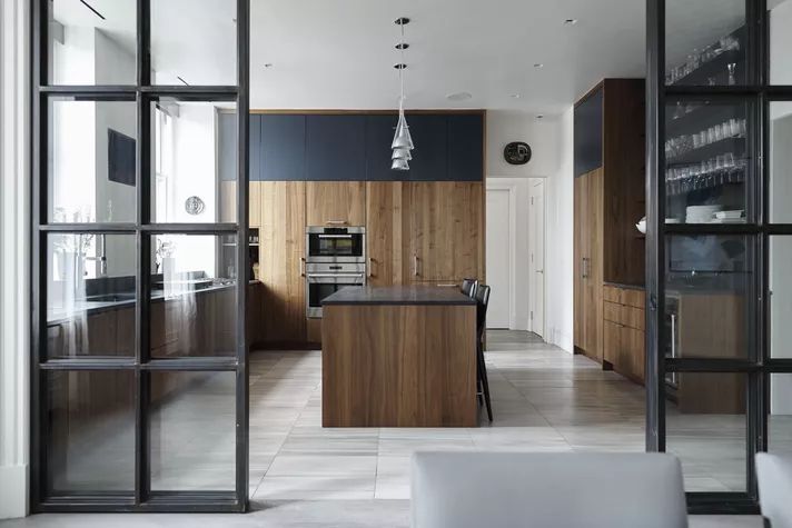 an open kitchen and living room with sliding glass doors