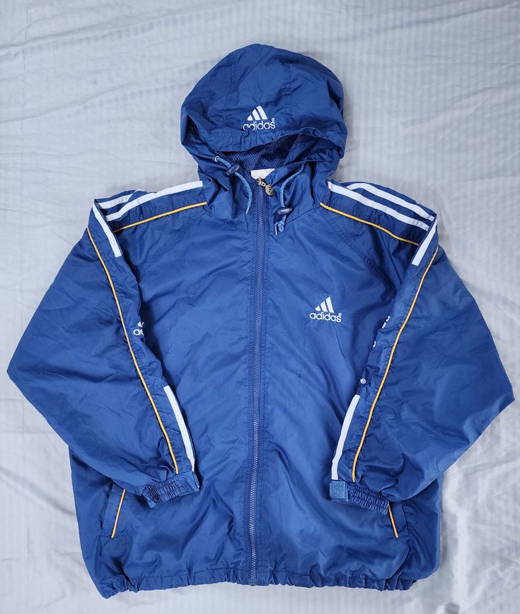 Vintage 1990s Adidas Equipment Blue White Yellow Mesh Lining Light Windbreaker Jacket Small In great condition  Normal wear  Small 26.5 x 25.5 Pit to Pit Any questions feel free to reach out! Adidas Skateboarding Jacket, Cheap Blue Adidas Bags, Cheap Blue Track Jacket For Sports, Cheap Vintage Blue Windbreaker, Vintage Blue Adidas Jacket, Adidas 90s Coat, Vintage Blue Outerwear For Sports, Adidas Equipment, Adidas Vintage