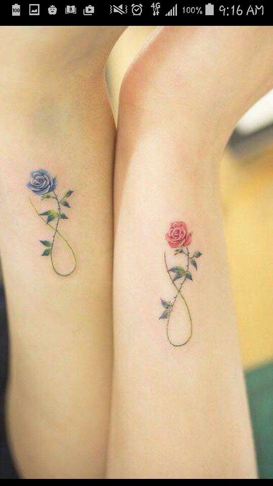 two rose tattoos on both arms, one is blue and the other has pink roses