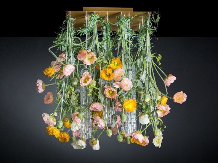 an arrangement of flowers hanging from the ceiling