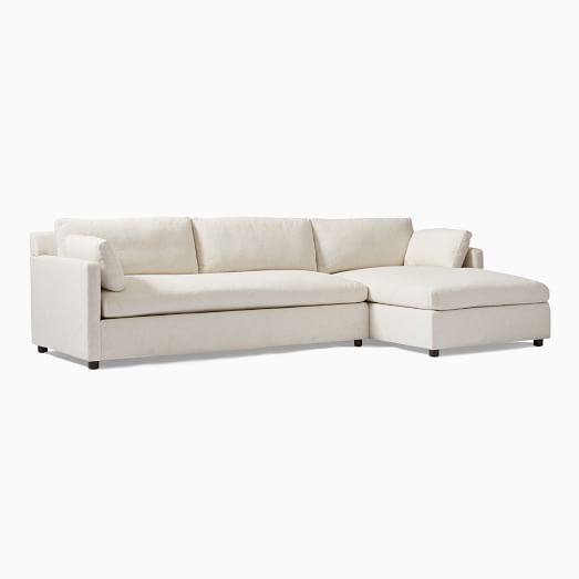 a white sectional sofa with chaise lounge