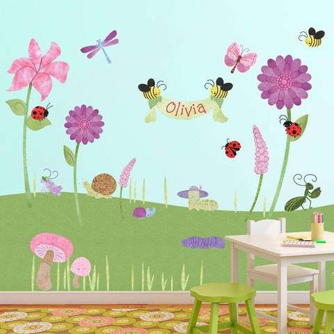 a child's room with flowers, butterflies and ladybugs on the wall