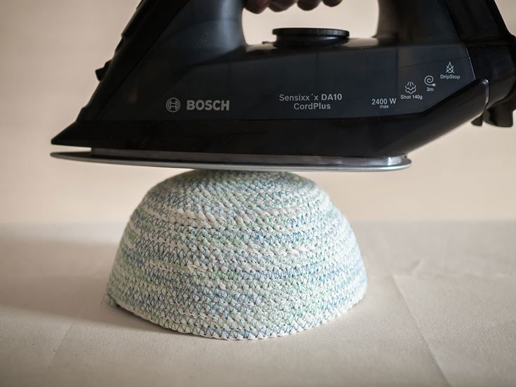 a black iron on top of a blue and white hat