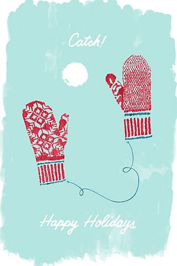 two red mittens with the words catch happy holidays written on them in white ink