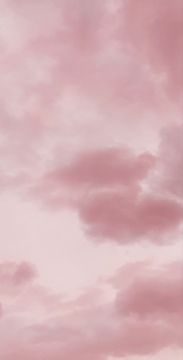 an airplane flying in the sky with pink clouds