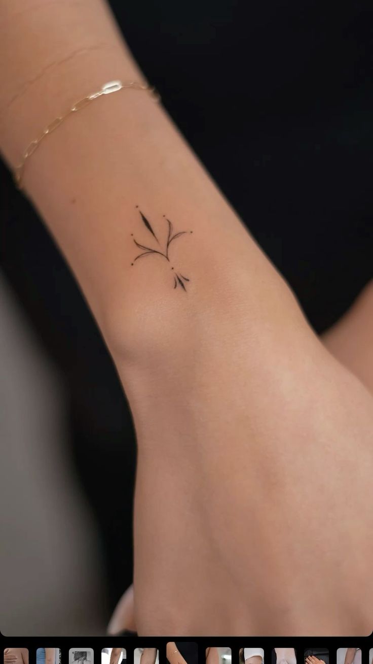 a woman's arm with a small flower tattoo on the left side of her arm