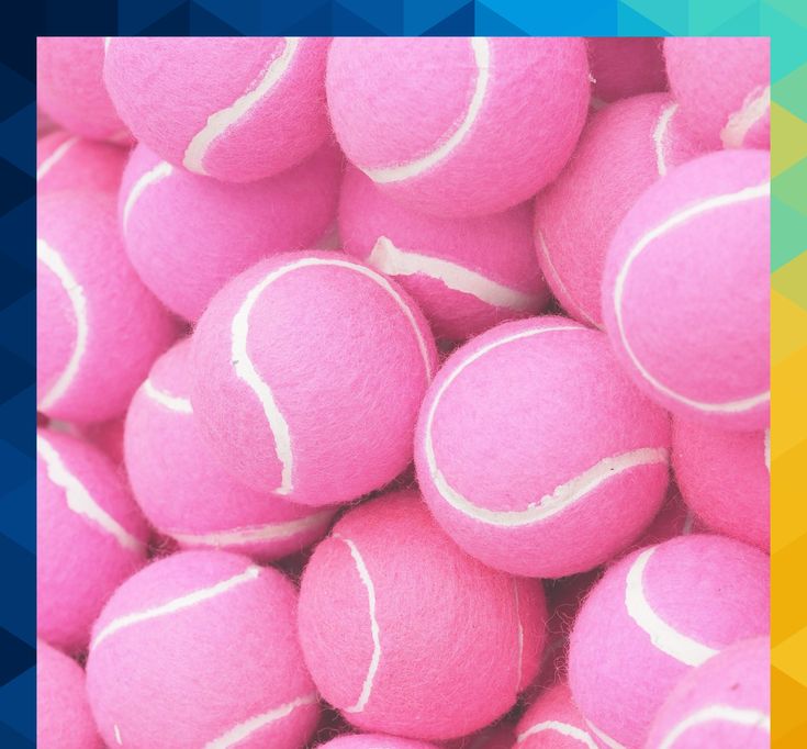 a pile of pink tennis balls sitting on top of each other