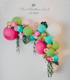 balloons and greenery are hanging on the wall in front of an instagramt for greenweddingshoes