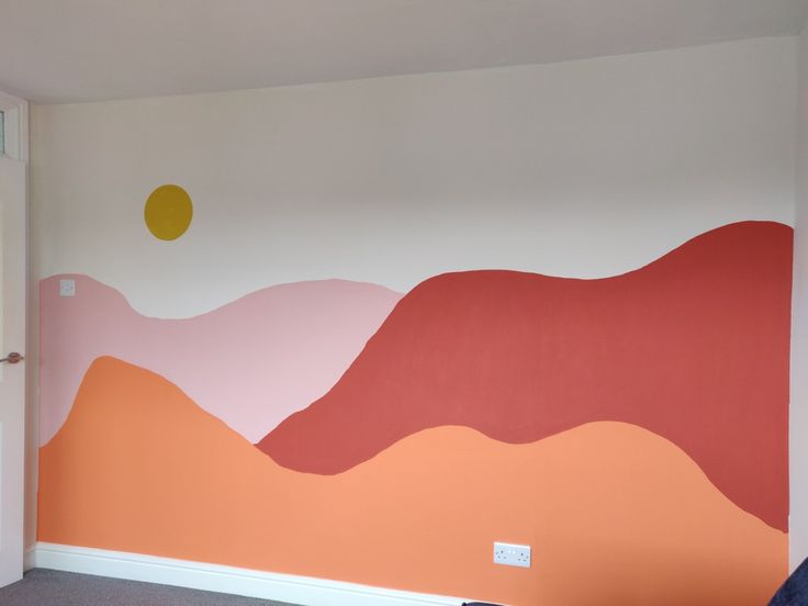 Pink, orange and red hills painted across a bedroom wall Diy Sun Mural Wall, Mountain Painting Simple Wall Murals, Simple Playroom Mural, Simple Colorful Wall Mural, Simple Wall Murals Diy Paint, Easy Mural Ideas Diy, Easy Murals To Paint, Daycare Wall Art, Diy Desert