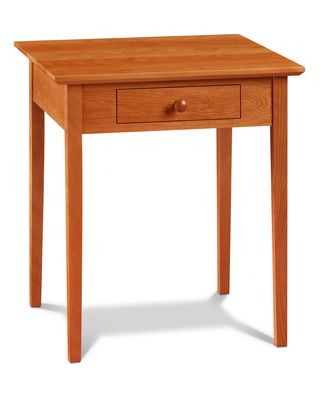 a small wooden table with one drawer on the top and two drawers on the bottom