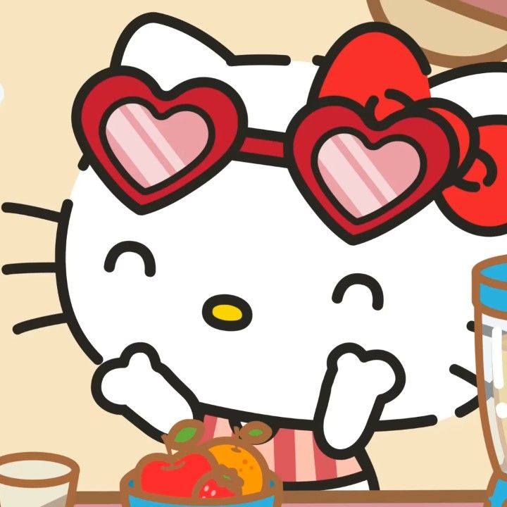 a hello kitty is standing next to a blender