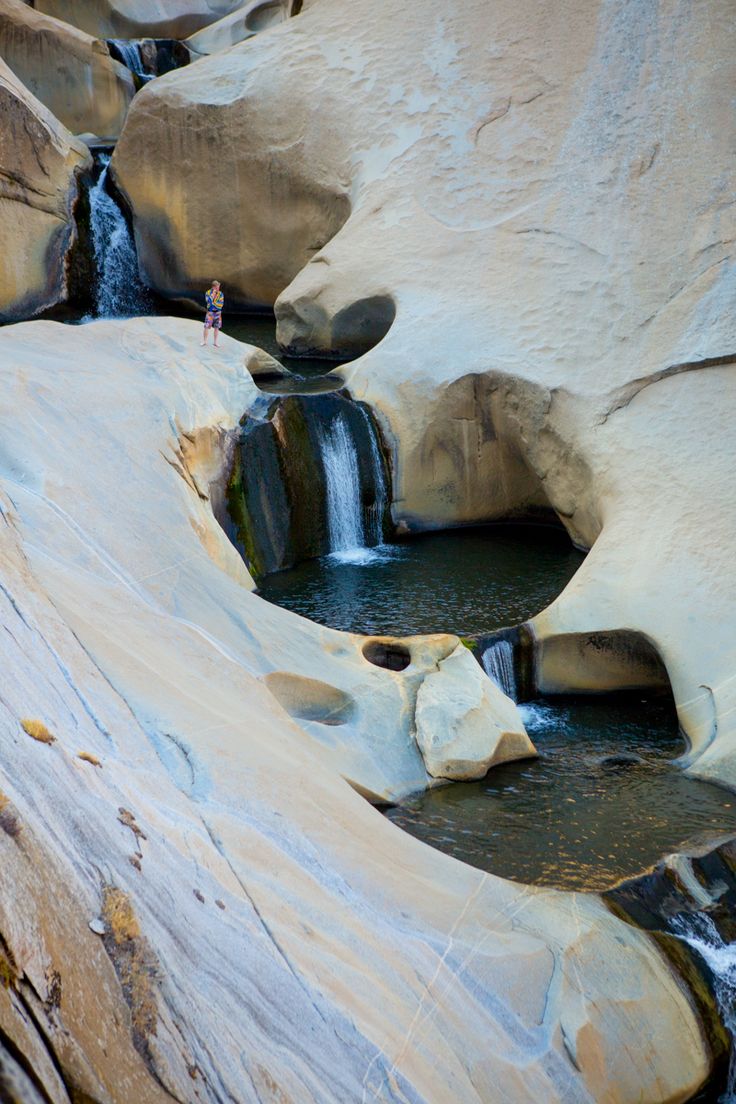 there is a waterfall in the middle of some rocks