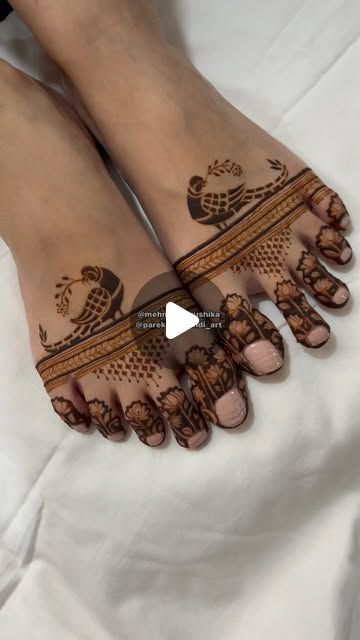 two feet with henna tattoos on them