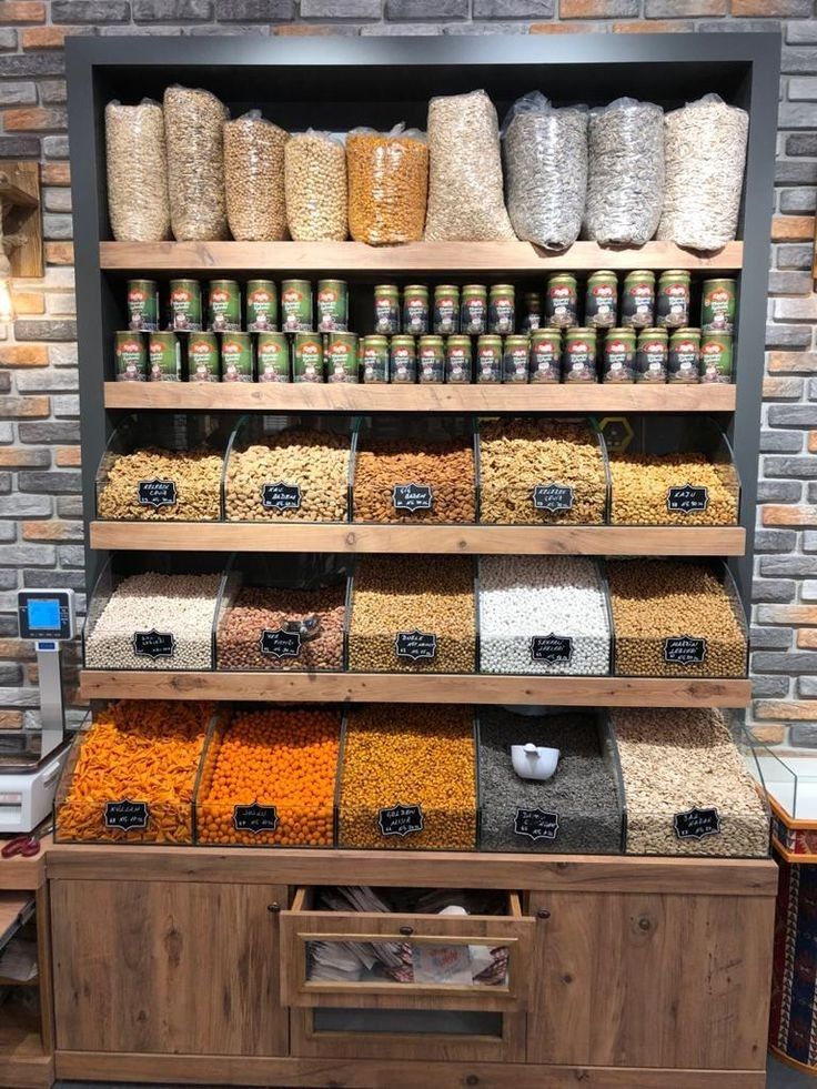 the shelves are filled with many different types of grains and cereals in bins