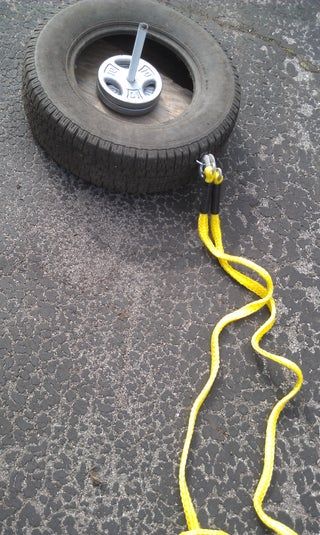 a yellow cord connected to a tire on the ground with it's wheels attached