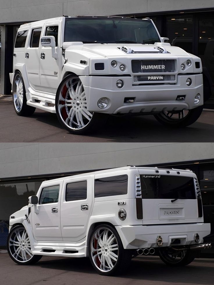 the white hummer is parked in front of a building