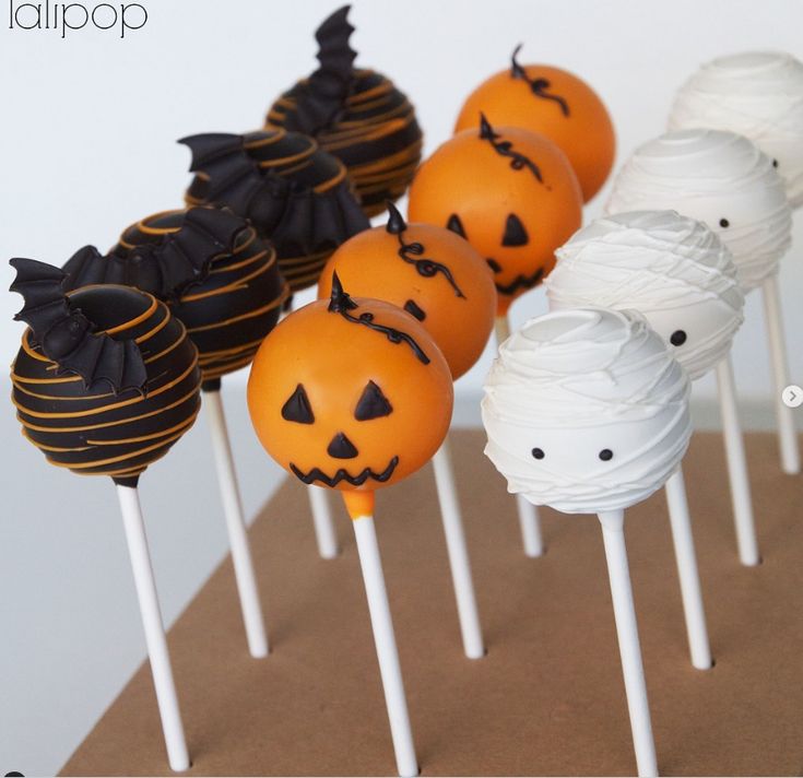 halloween cake pops with pumpkin faces on them