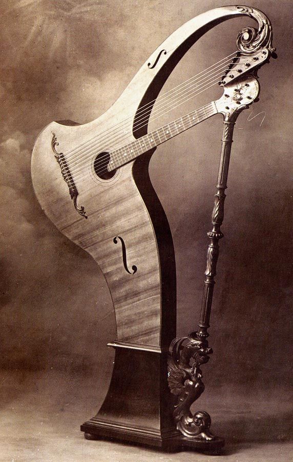 an old fashioned musical instrument with a long neck and two strings on it's stand