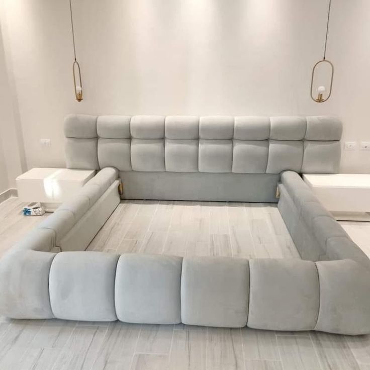 a large gray couch sitting on top of a white floor