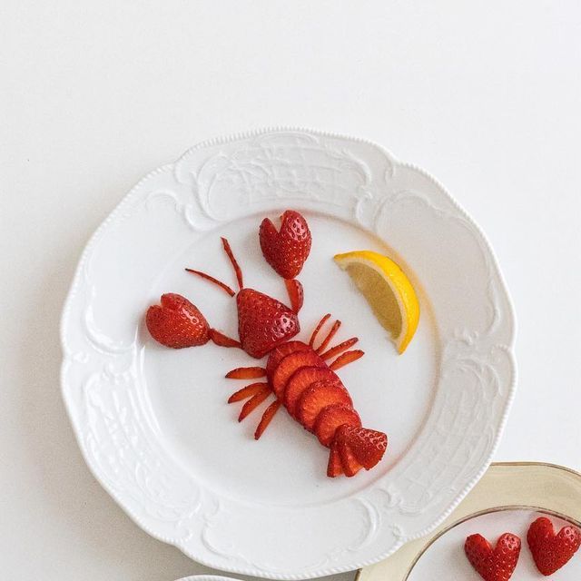 a plate with strawberries and lemon slices on it