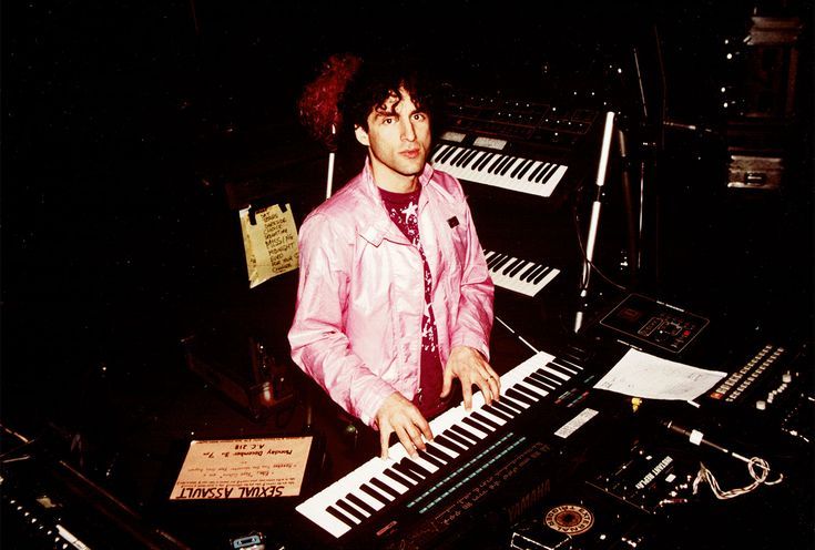 a man standing in front of an electronic keyboard