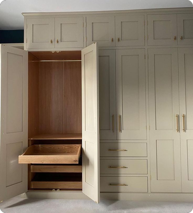 an empty closet with drawers and cupboards in it