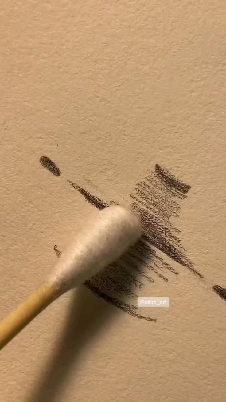 a close up of a paint brush on the wall